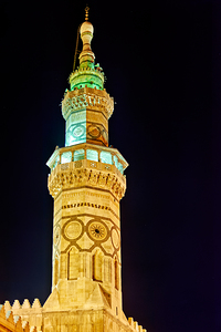Minaret of a mosque in Damascus at night with lights shining