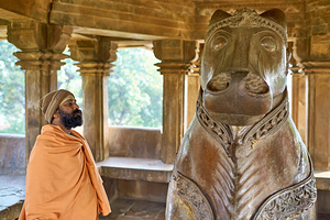 Visitors in Nandi shrine at ancient temple in Khajuraho