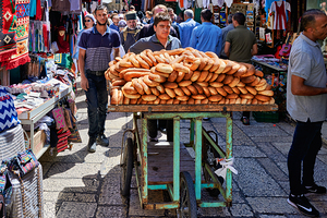 Carrying bread through the streets of old Jerusalem in Israel