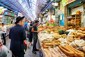 Visitors explore Mahane Yehuda Market in Jerusalem during daytim