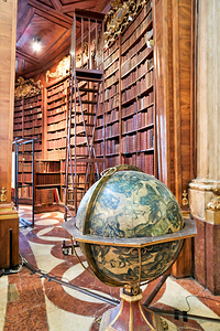 Historic library interior with globe books and rolling ladder.