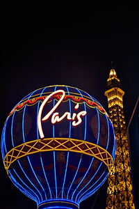 Signs light up the Las Vegas Strip at night near Paris by Marco Brivio