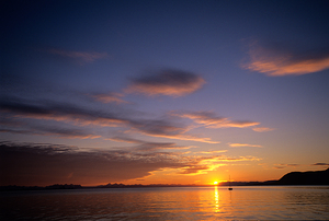 Midnight sun sets over water in Longyearbyen Norway by Marco Brivio