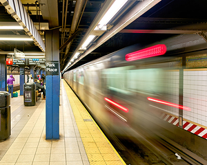 A subway train moves quickly at Park Place station in Manhattan
