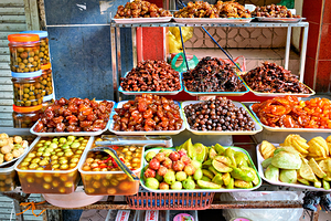 Fruit and snack stall in Hanoi Vietnam during the day by Marco Brivio