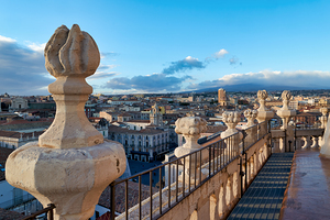 Elevated view of Catania showing rooftops and mountains in dista