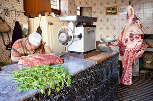 Butcher working in the souk of Meknes Morocco during market hou