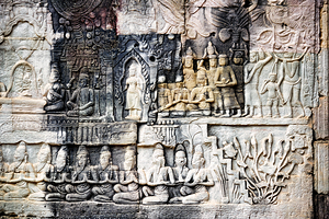 Ancient stone bas reliefs depicting figures and decorative eleme