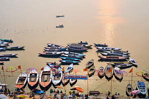 Sunrise at Ganges River in Varanasi with boats and activities