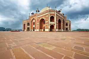 Humayuns Tomb stands in Delhi under a cloudy sky