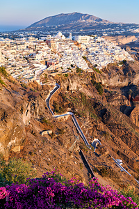 Picturesque Santorini cliffside town with winding path and vibra