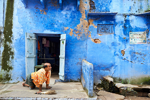 Man sweeps in front of home in Bundi Rajasthan during the day
