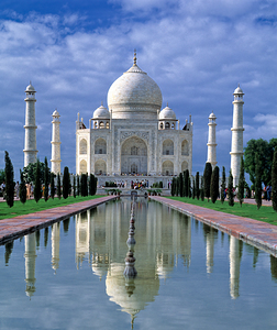 Taj Mahal stands in Agra with clear sky and reflecting pool