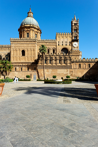 Palermo Cathedral in Sicily with clear blue sky and visitors by Marco Brivio