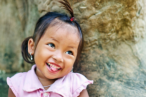 Joyful young girl with a playful smile and tongue out.