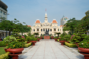 Ho Chi Minh City Hall and gardens in Saigon with statue
