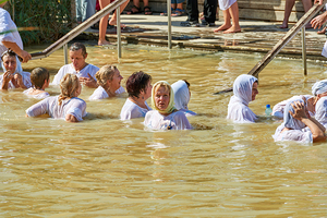 Visitors participate in baptism ceremony at Jordan River site