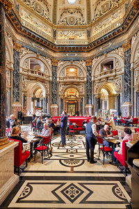 People dining in a grand ornate museum cafe.