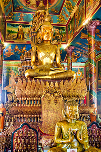 Ornate golden Buddha statue in a richly decorated temple.