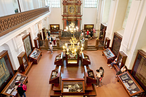 People explore a grand museum or synagogue with historical exhib