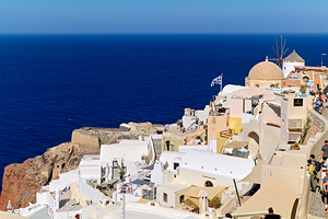 Santorinis iconic white buildings and windmill overlooking the 