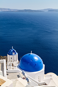 Santorinis blue domes and caldera view.
