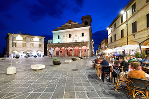 Montefalco Umbria Italy. Piazza del Comune at sunset. People eating out