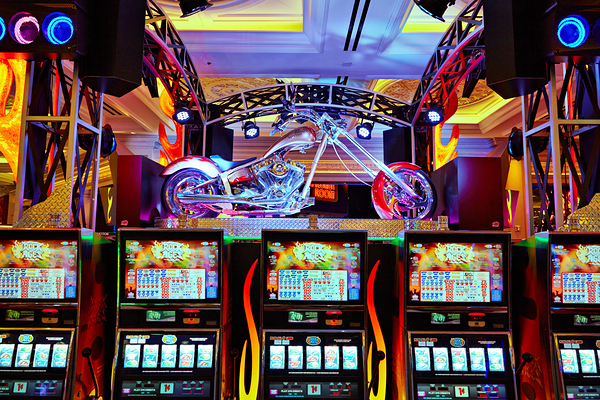 Slot machines and motorcycle display at Venetian Hotel Casino by Marco Brivio