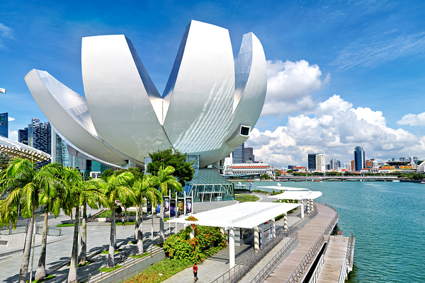 Visitors enjoy view of ArtScience Museum in Singapore near water Print
