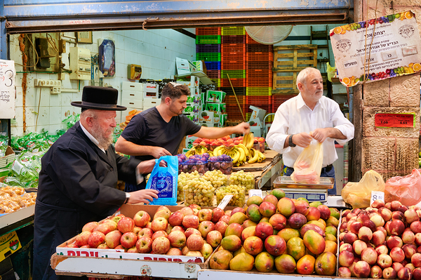 Vendors sell fresh produce at Mahane Yehuda Market in Jerusalem by Marco Brivio