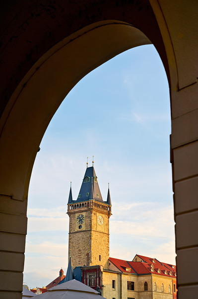 Historic clock tower framed by an archway. by Marco Brivio