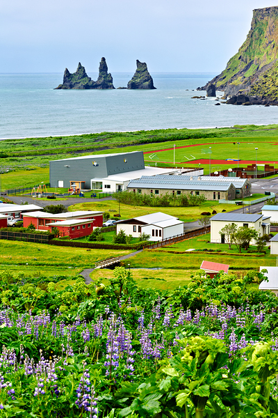 Coastline view of Reynisfjall and Vik town in Iceland by Marco Brivio