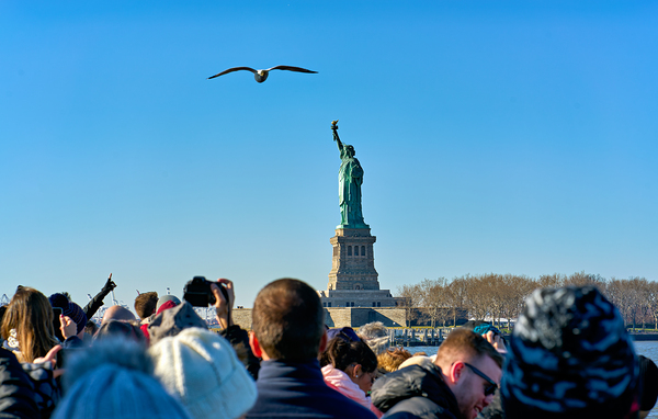 Tourists travel to Liberty Island by ferry in Manhattan New Yor Digital Download