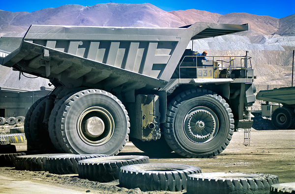 Giant mining dump truck in a dusty mountain quarry. Print