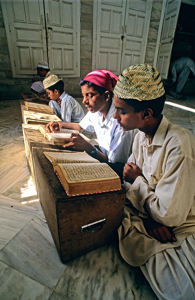 Students study in Quranic school madrasa in Pakistan Print