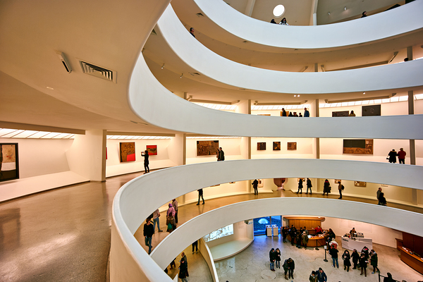 People walk and look at art inside the Guggenheim Museum in New  by Marco Brivio
