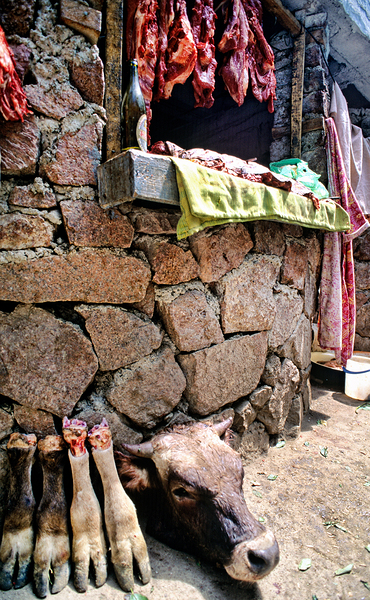 Butcher shop on street in Uzbekistan shows meat and cow parts Print