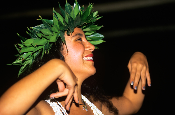 Smiling woman dances in traditional dress on Easter Island by Marco Brivio