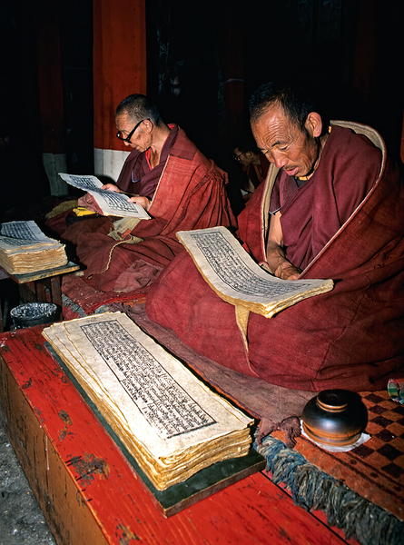 Monks read sacred texts in a Tibetan temple at night Digital Download