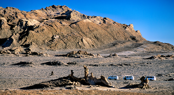Arid mountain landscape with vans on a desert road. Digital Download