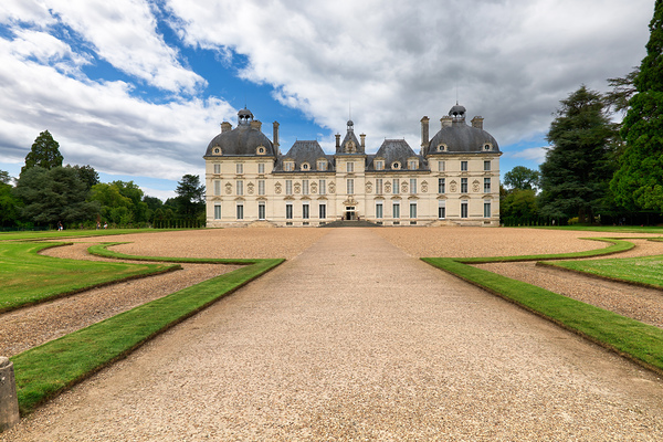 Visit Cheverny Chateau in France with lush gardens and blue skie by Marco Brivio