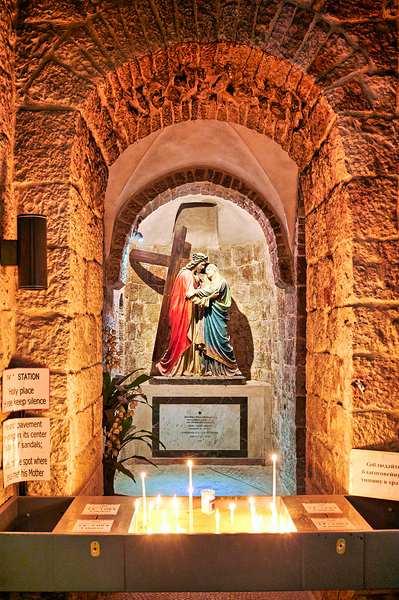 Statue of Mary and Jesus in a chapel with candles Print