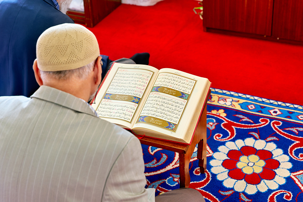 Man reading Quran inside Fatih Mosque in Istanbul Turkey Print