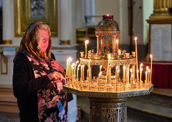 Woman lights candles at Alexander Nevsky Lavra Print