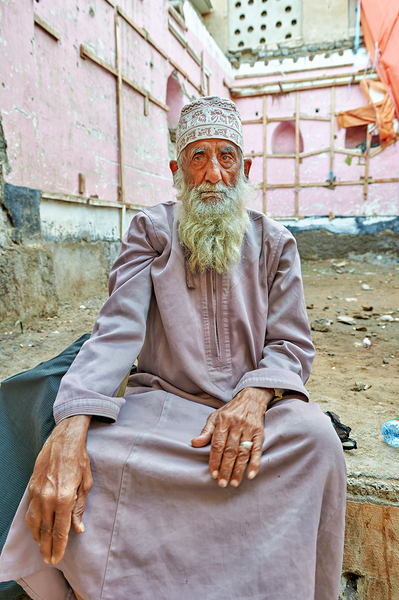 Old man sitting in a historical site in Muscat Oman Print