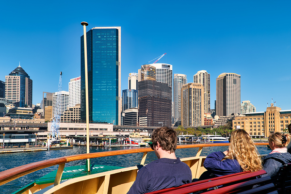 Ferry passengers enjoy city skyline view. Print