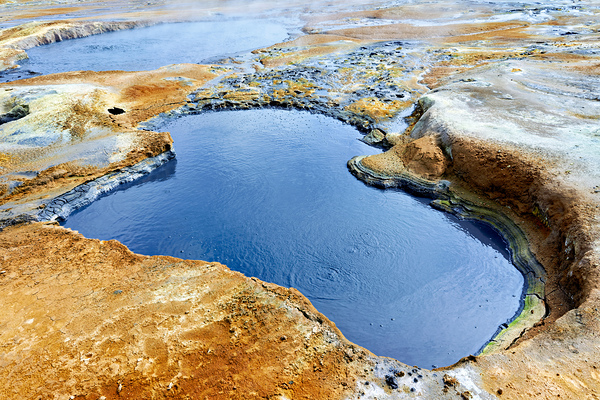 Exploring Hverir hot springs in Iceland during daytime by Marco Brivio