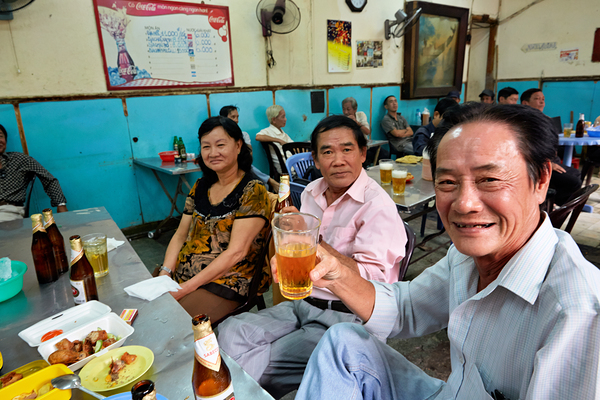 People enjoying time together in a cafe in Ho Chi Minh City Print