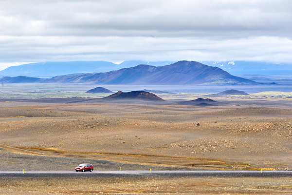 Car driving along Hringvegur road in Iceland landscape by Marco Brivio