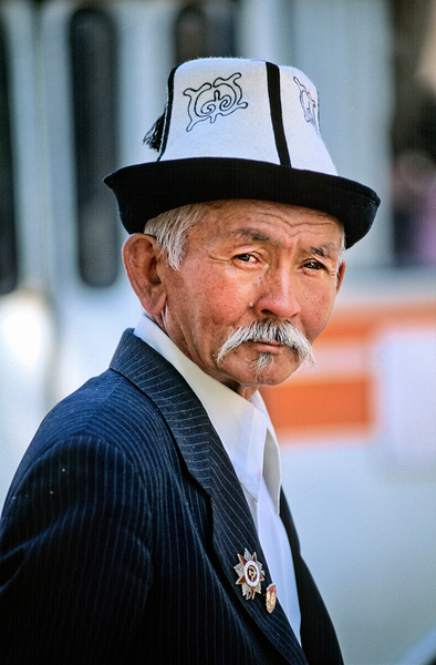Elderly man in traditional hat walks in Bukhara Uzbekistan Print